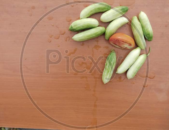 Vegetables( Ivy Gourds And Tomato)Isolated On Wooden Surface