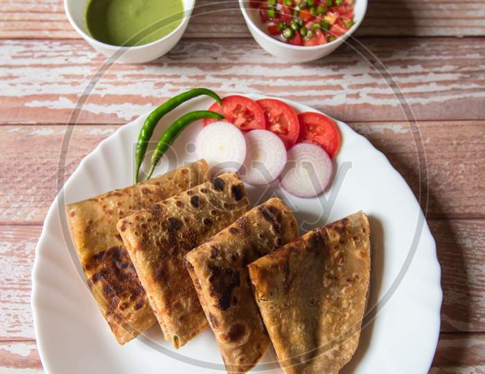 Vertical view of Indian dish alu paratha in a plate