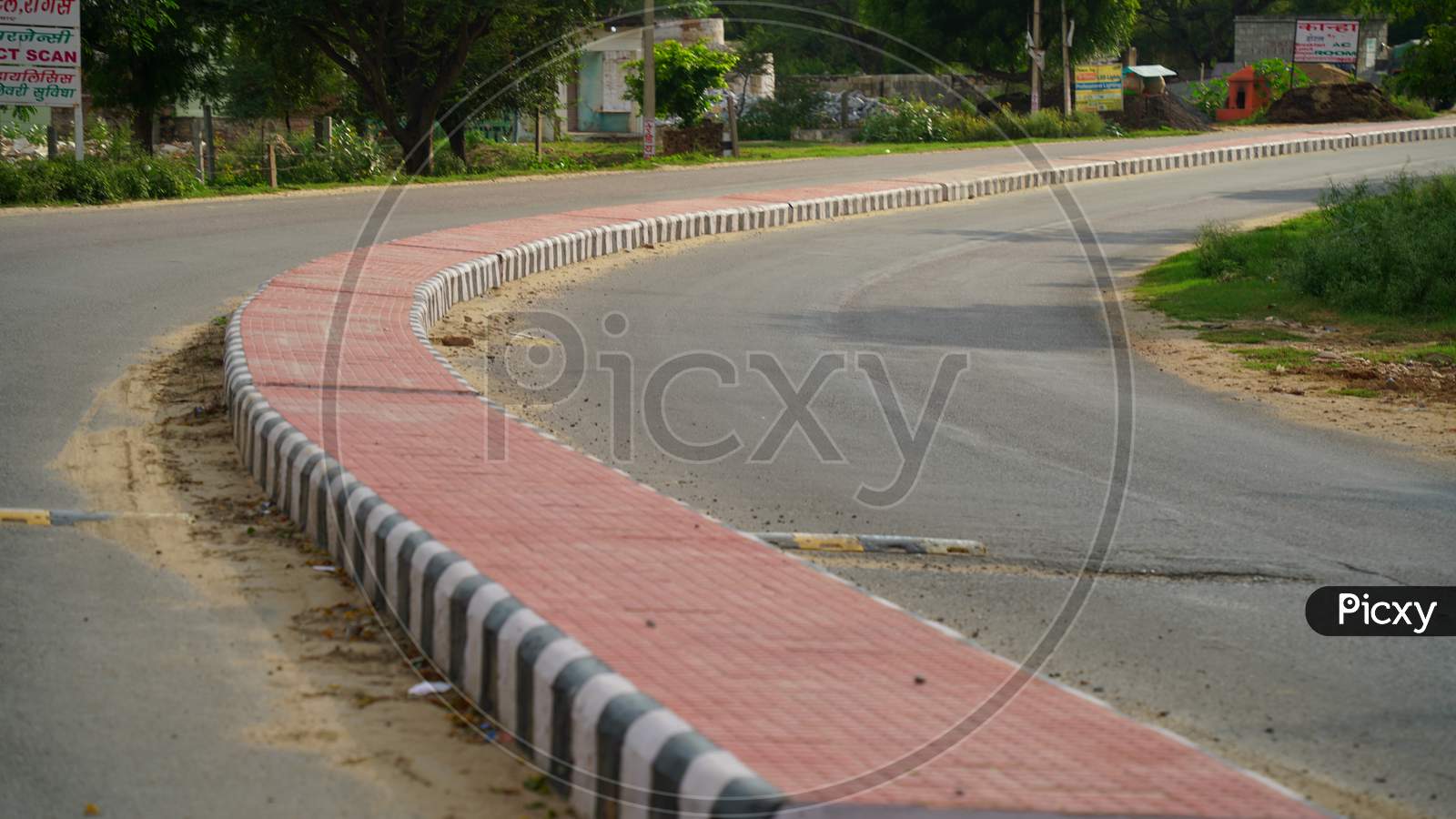 Pink Color Road Divider In A Countryside Road In India
