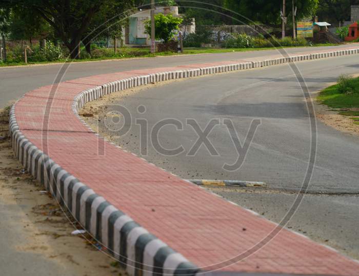 Pink Color Road Divider In A Countryside Road In India