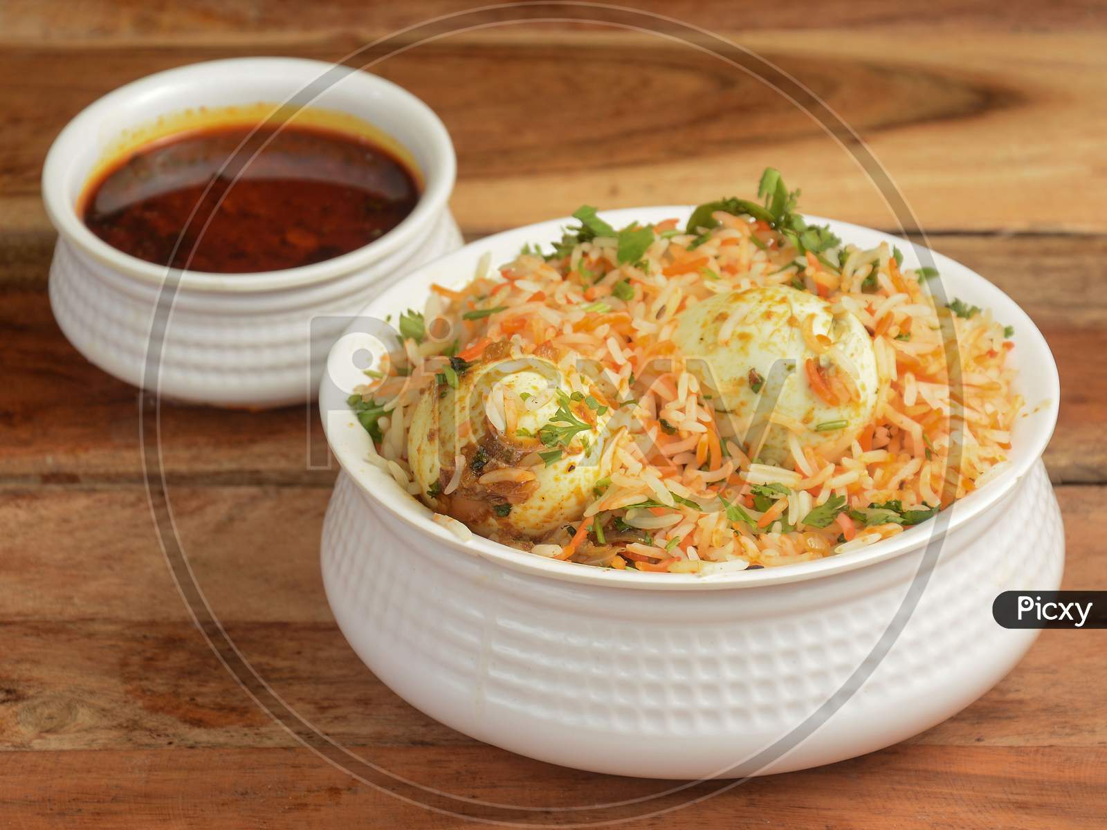 Egg Biryani - Basmati Rice Cooked With Masala And Spices And Served With Boiled Eggs And Brinjal Curry, Selective Focus