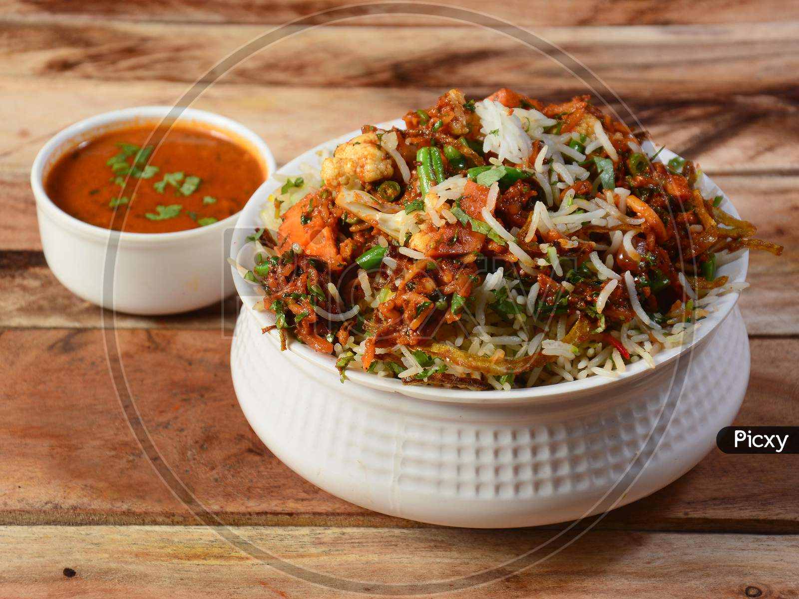 Traditional Hyderabadi Vegetable / Veg Dum Biryani With Mixed Veggies Served With Curry, Selective Focus
