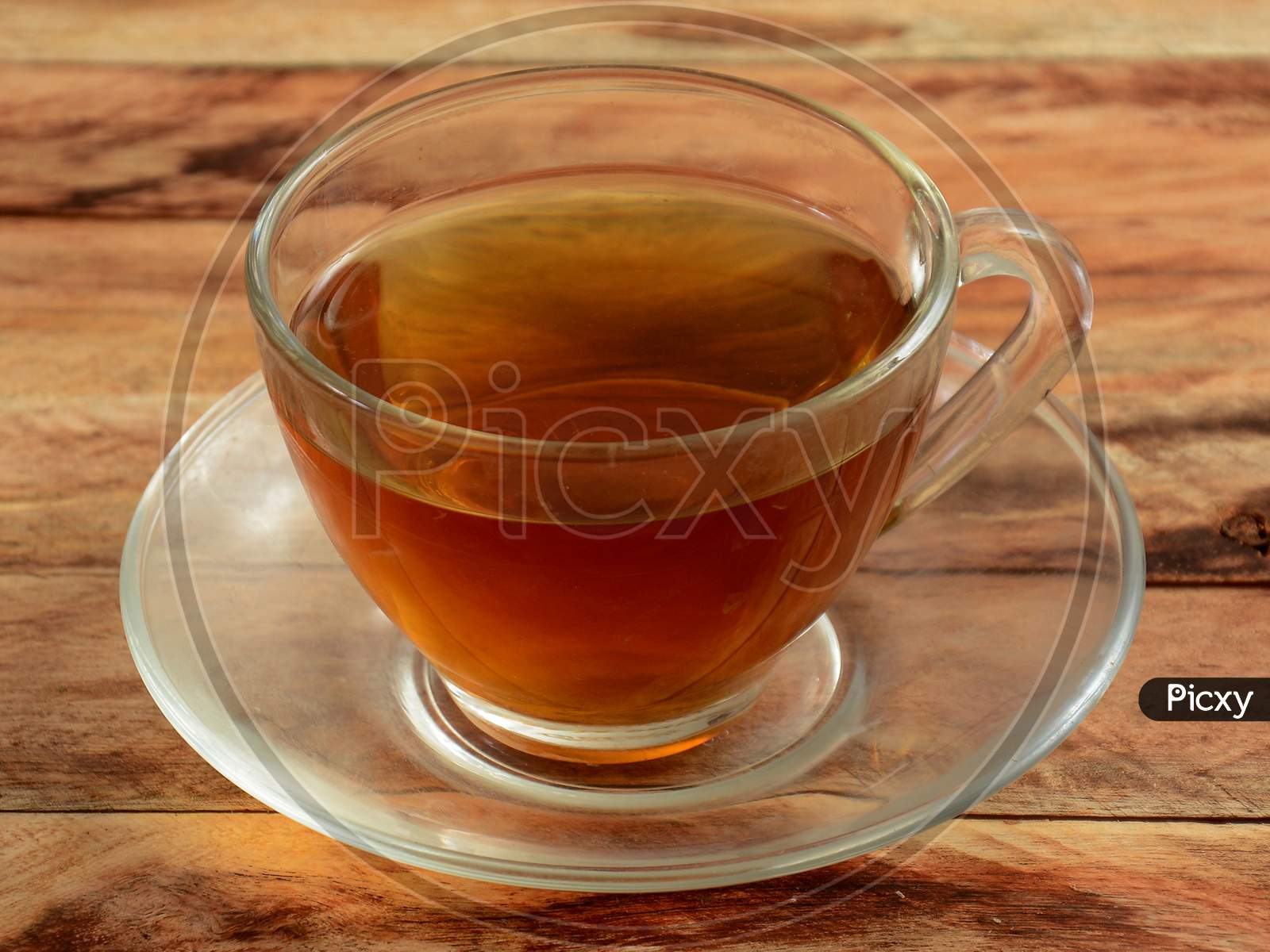 Freshly Brewed Pepper Mint Tea In Glass Cup On Rustic Wooden Background, Selective Focus