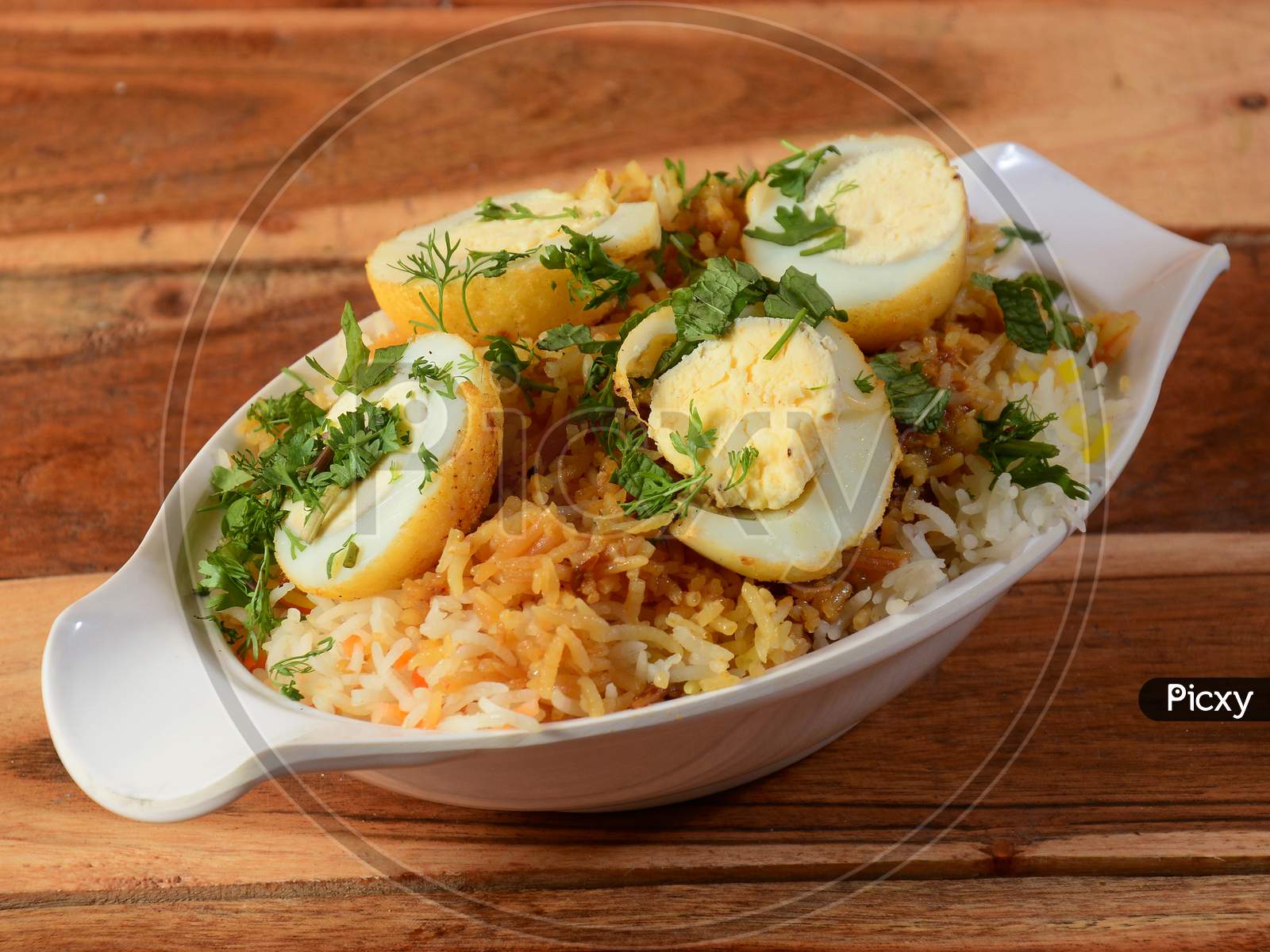 Egg Biryani - Basmati Rice Cooked With Masala And Spices And Served With Sliced Boiled Eggs, Selective Focus