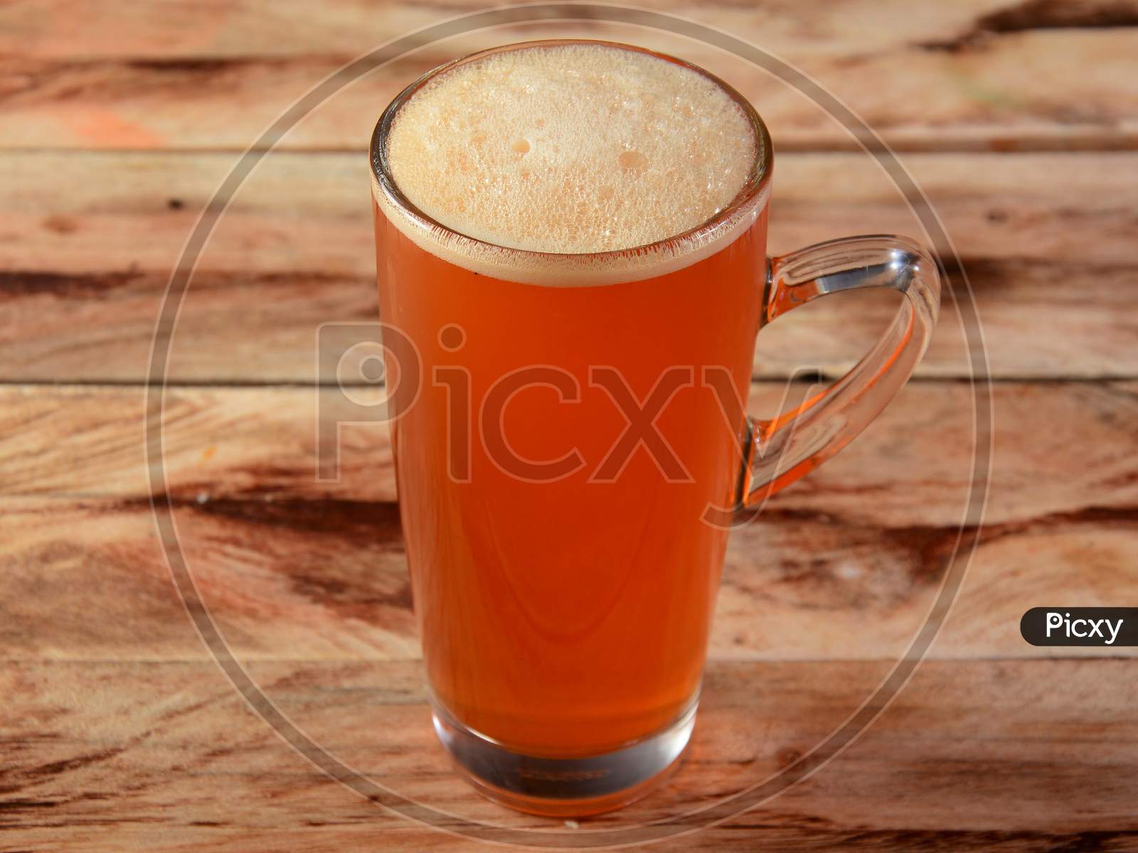 Glass Of Peach Ice Tea On Rustic Wooden Background