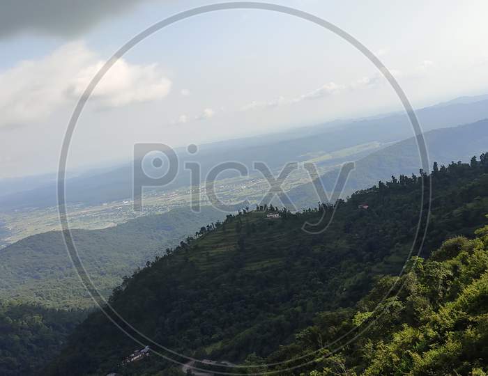 Scenic view of mountain in cloudy weather