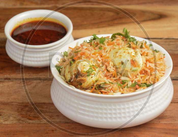 Egg Biryani - Basmati Rice Cooked With Masala And Spices And Served With Boiled Eggs And Brinjal Curry, Selective Focus