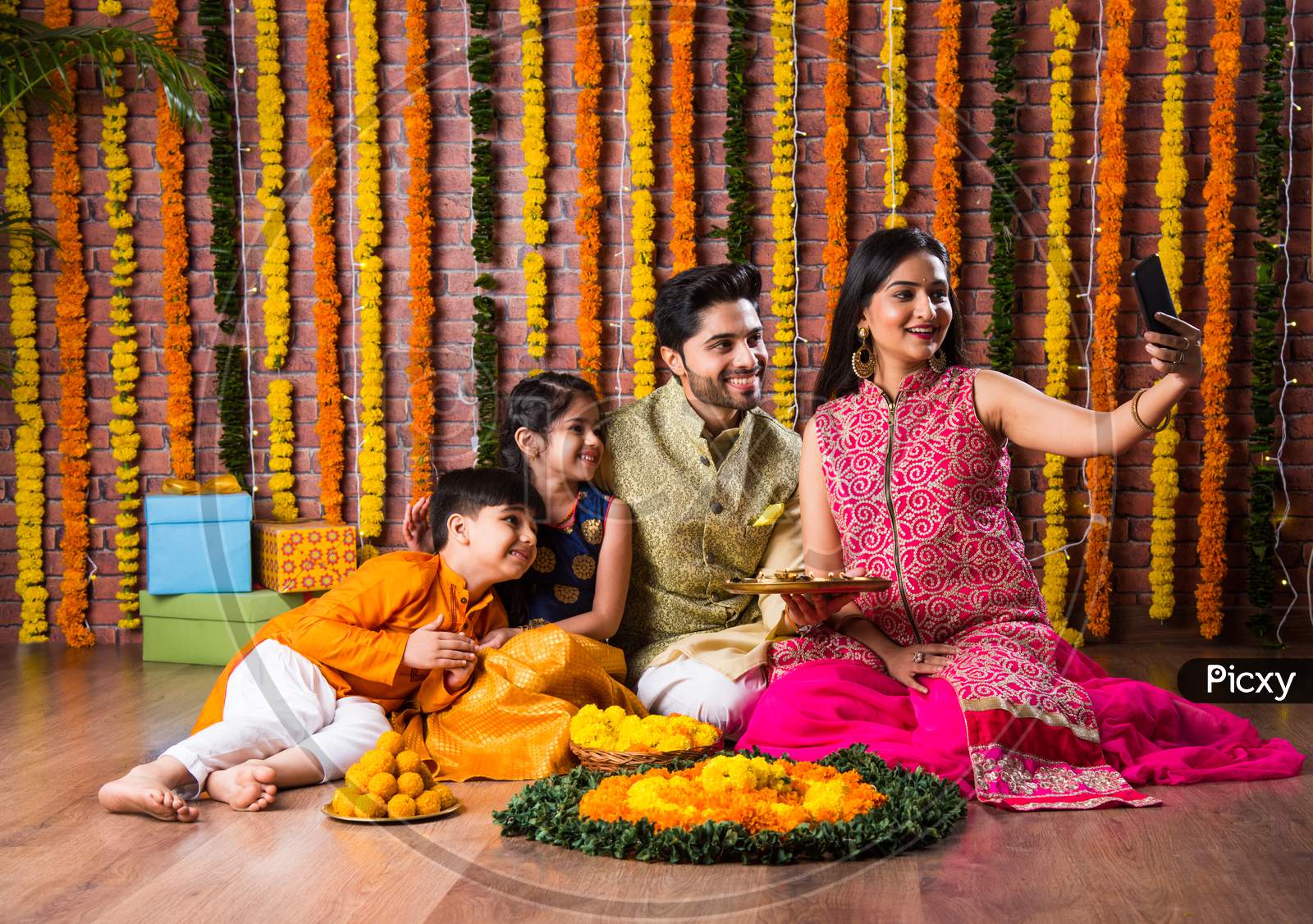 Asian Indian Young Family Of Four Celebrating Diwali, Bhai Dooj Or Raksha Bandhan