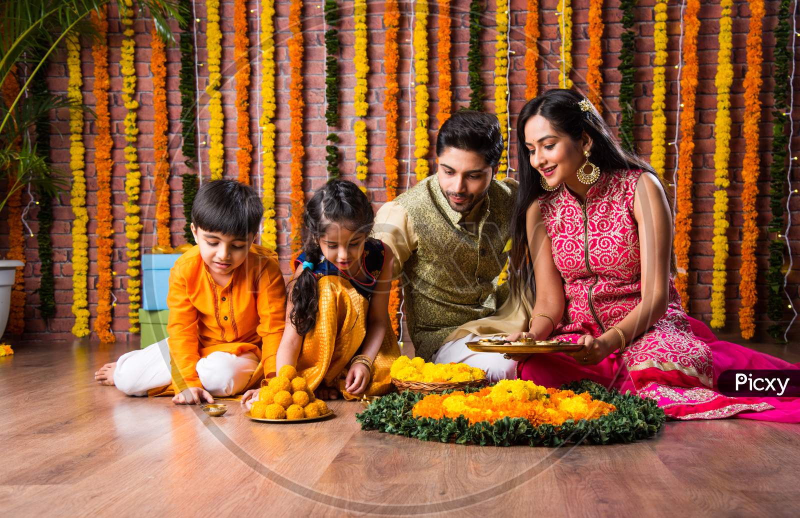Indian Family Together Arranging Oil Lamp Or Diya For Diwali Festival Celebrations