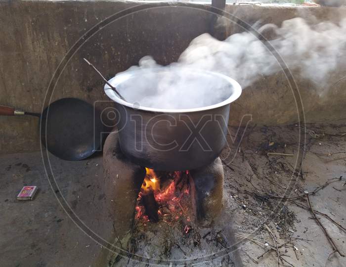White Smoke Coming Out From The Pan. Cooking Rajasthani Food On Mud Challah Or Stove Or Oven.