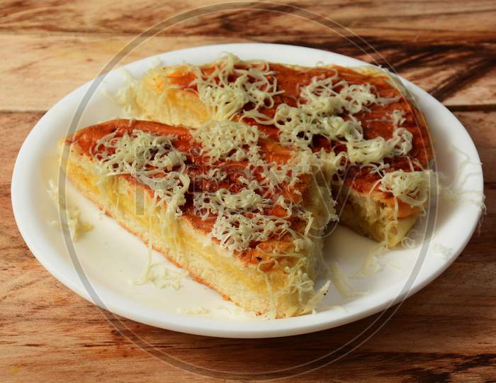 Cheese Grilled Bun Maska An Iranian Popular Dish That Contains Butter And Sweet Bun Topped With Cheese Served In White Plate, Selective Focus