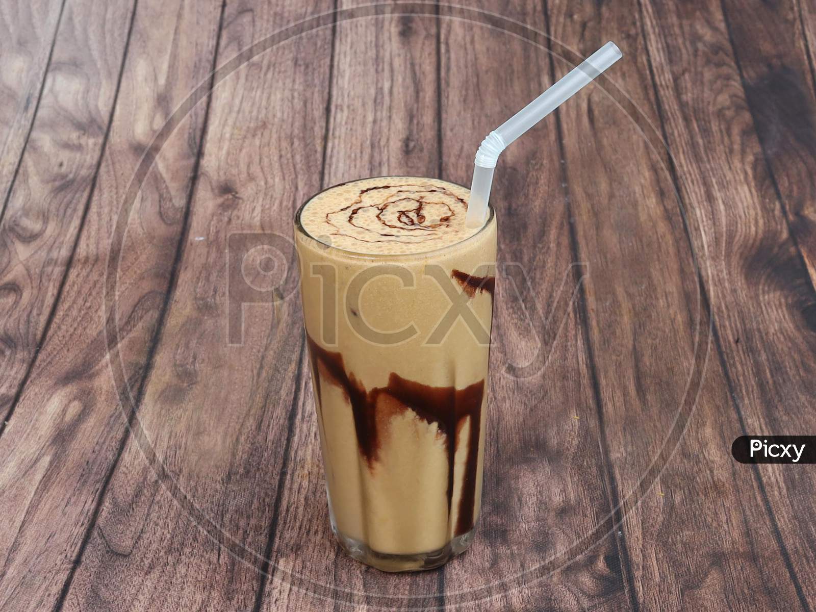Thick Cream Cold Coffee In A Tall Glass With Cream Poured On A Old Rustic Wooden Table.