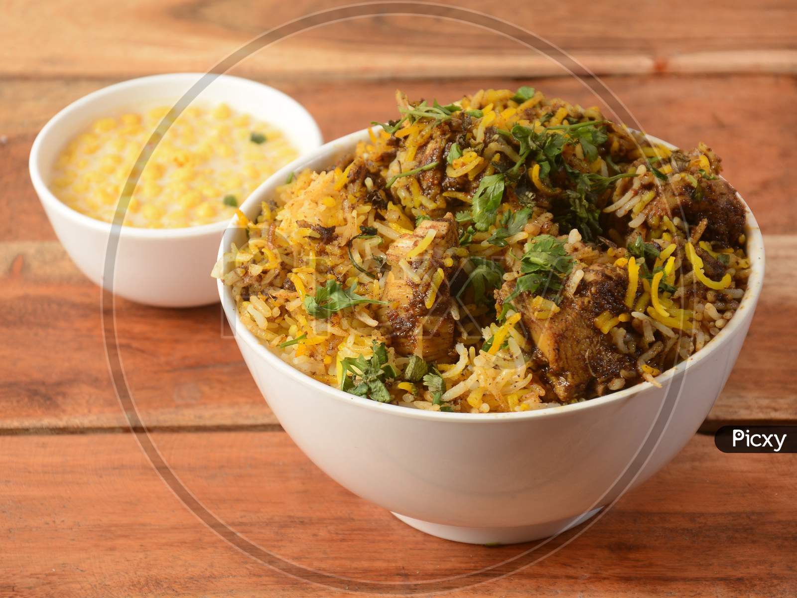 Traditional Hyderabadi Chicken Dum Biryani Made Of Basmati Rice Cooked With Masala Spices, Served With Boondi Raita, Selective Focus