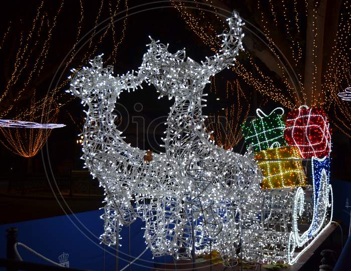 Sleigh With Reindeer And White Lights At Christmas.