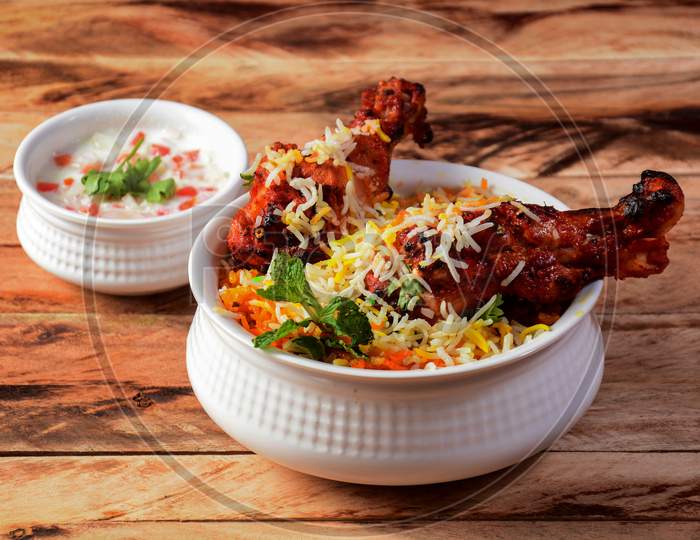 Chicken Tikka Biryani Made Of Basmati Rice Cooked With Masala Spices, Served With Yogurt, Selective Focus