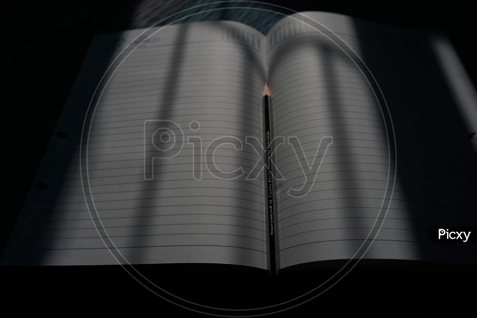 Notebook in middle pencil for writing the thought and quote