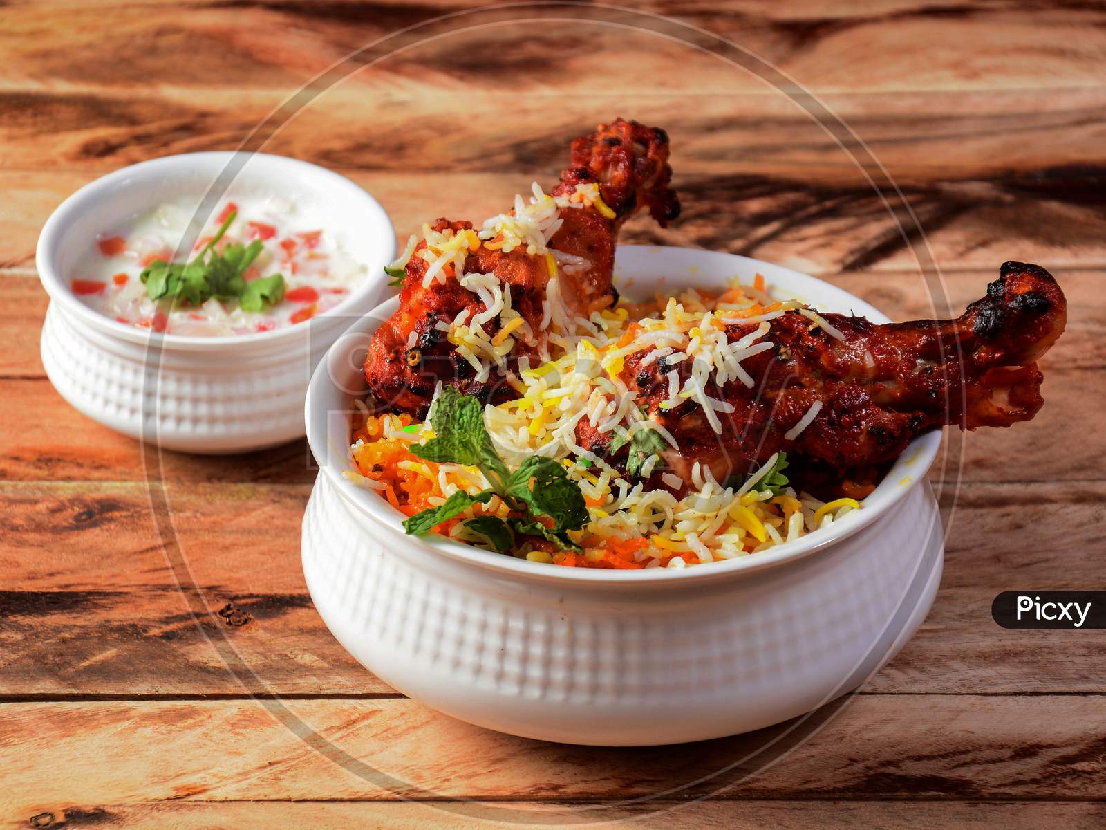 Chicken Tikka Biryani Made Of Basmati Rice Cooked With Masala Spices, Served With Yogurt, Selective Focus