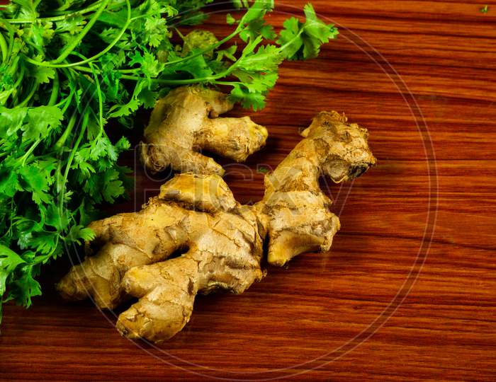 Raw Ginger Pieces With Coriander On The Table