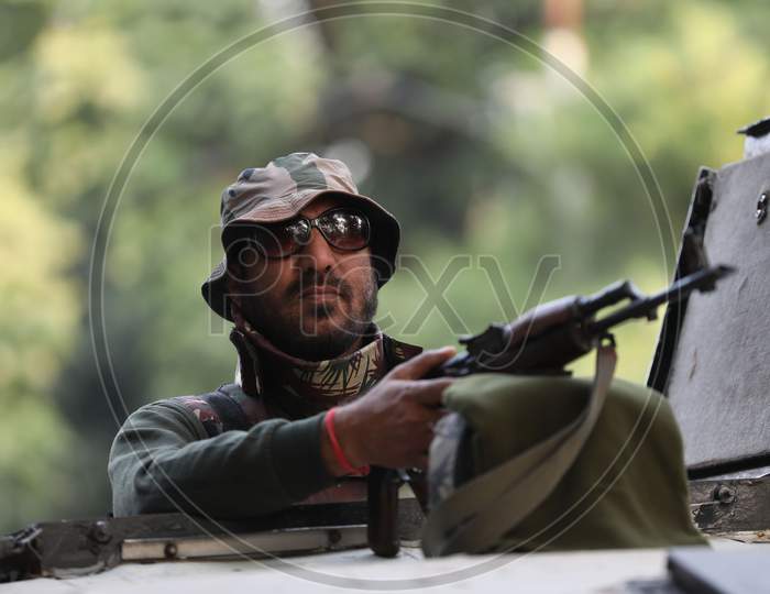 security personnel stands guard outside the Civil Secretariat as it reopens following the annual 'Darbar Move', in Jammu,Nov. 9, 2020.