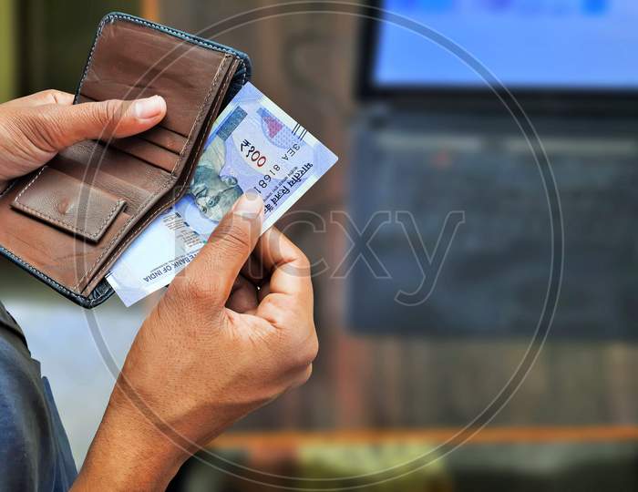 Young Man Taking Indian Currency Notes Or Banknotes Out From Wallet Top View With Copy Space
