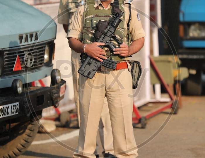 security personnel stands guard outside the Civil Secretariat as it reopens following the annual 'Darbar Move', in Jammu,Nov. 9, 2020.