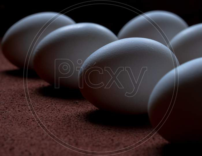 White Eggs On A Brown Background
