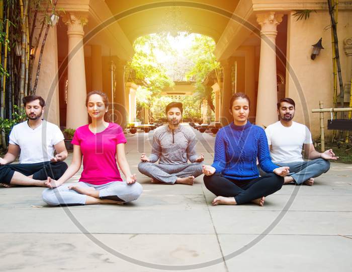 Indian Asian People Doing Yoga Or Meditation Outdoors - Health And Fitness Concept