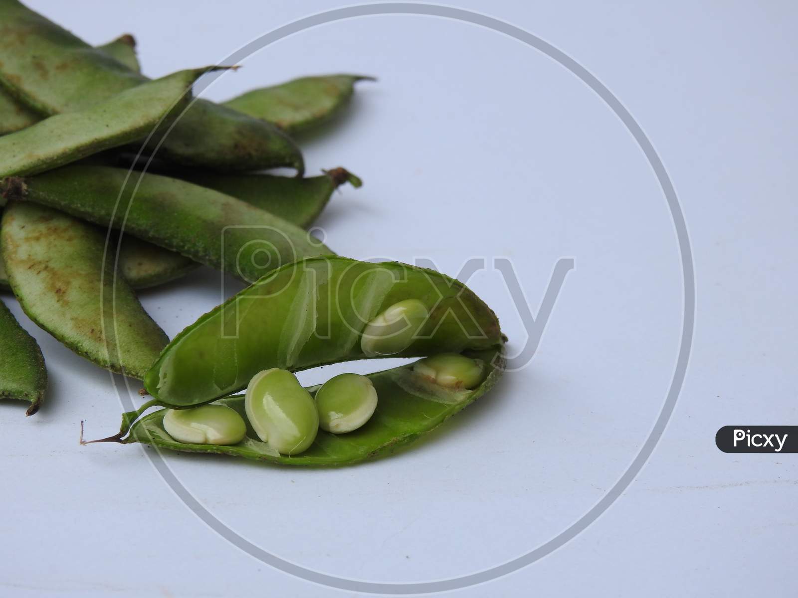 Indian Hyacinth Beans or Avarekai with and without peeled seeds isolated on white background