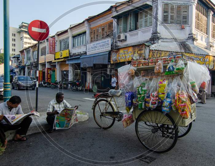 People Lifestyle Read Newspaper At The Street Of Old Heritage Penang.