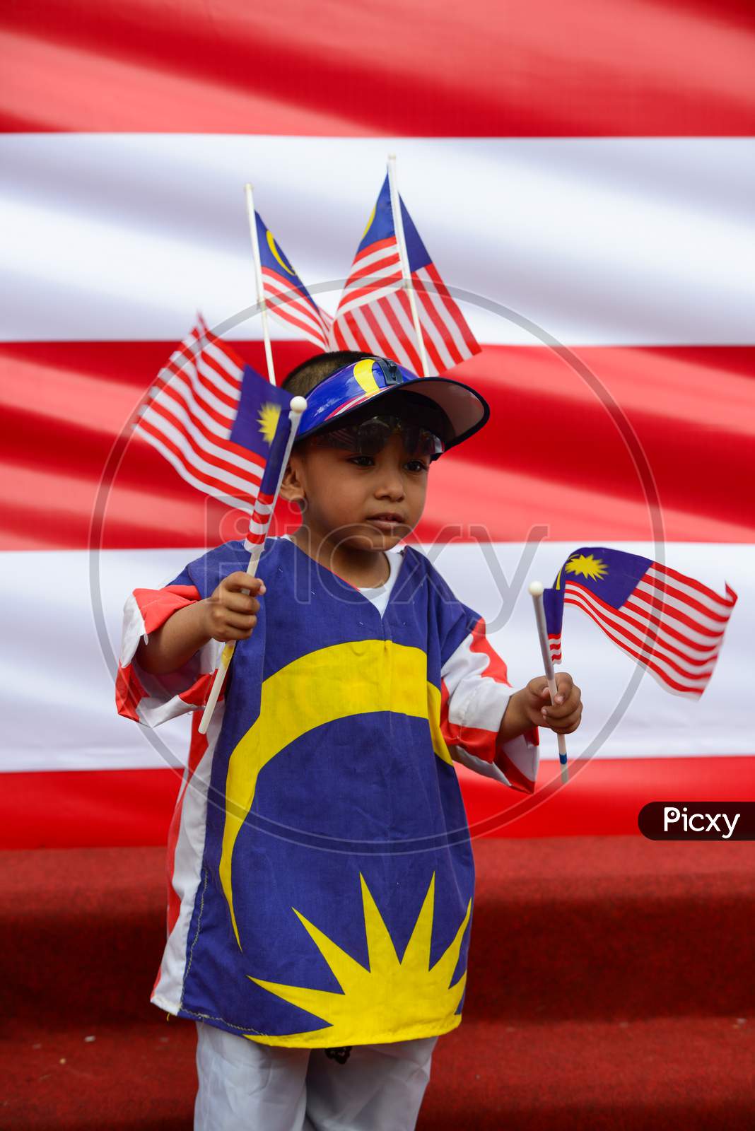 A Kids Wear Malaysia Flag And Hold Malaysia Flag