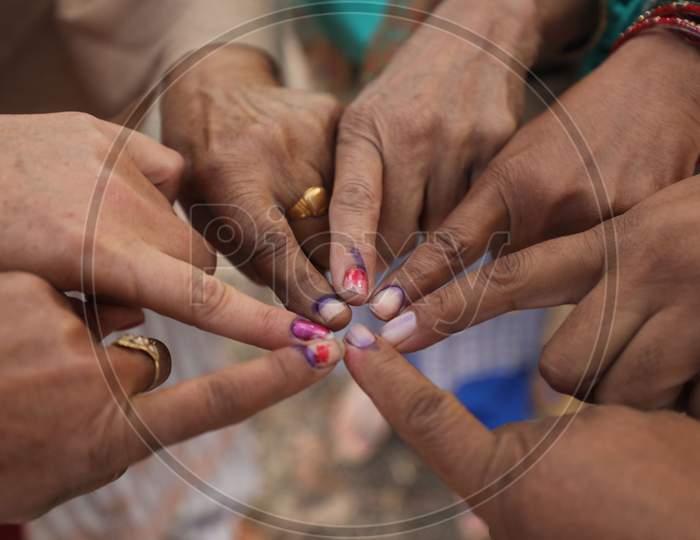 Villager women show their fingers marked with indelible ink after casting their votes during the second phase of the District Development Council (DDC) election at Meen Sarkar Sambha in Jammu, Tuesday, Dec. 1, 2020.