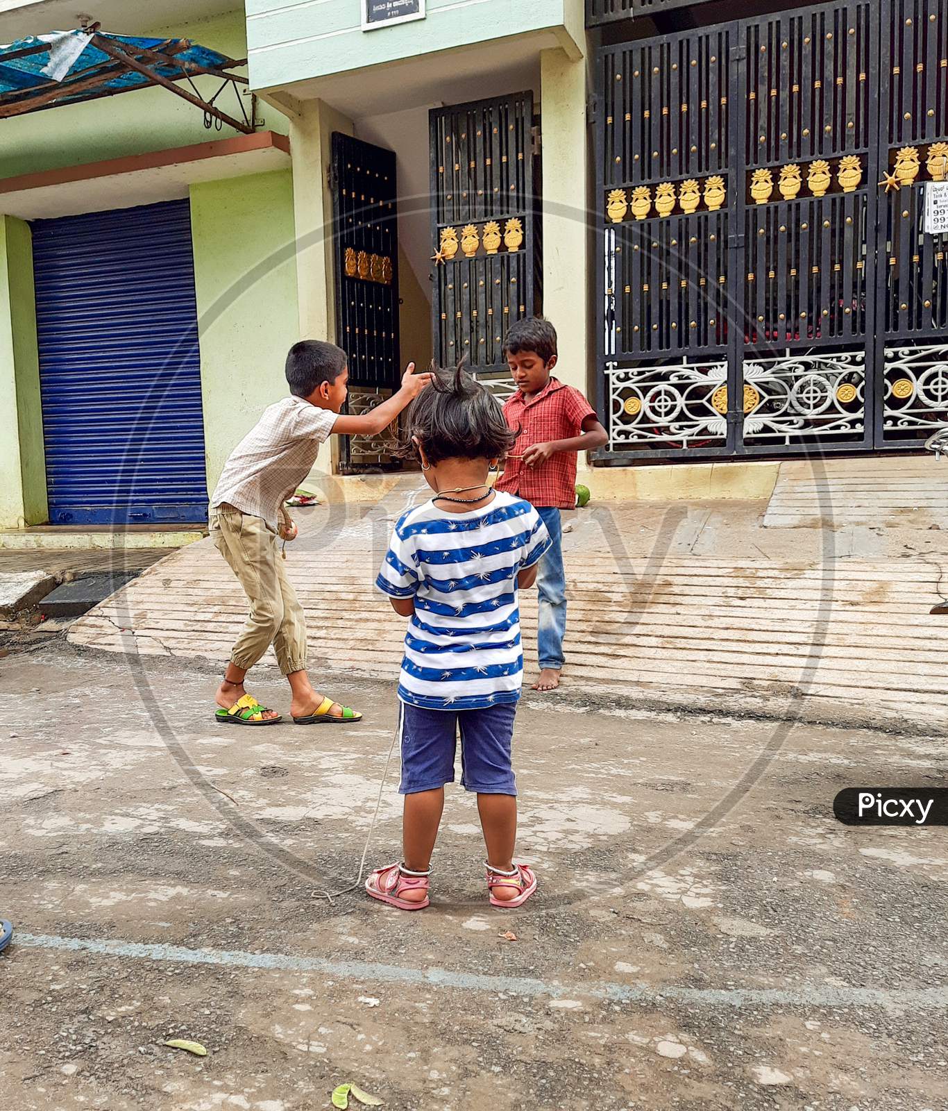 Image of Closeup of different age group kids playing Buguri or Spinning ...