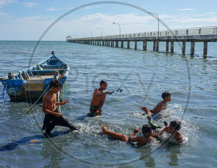 Malays Kids Play Water Near Teluk Bahang Fishing Village