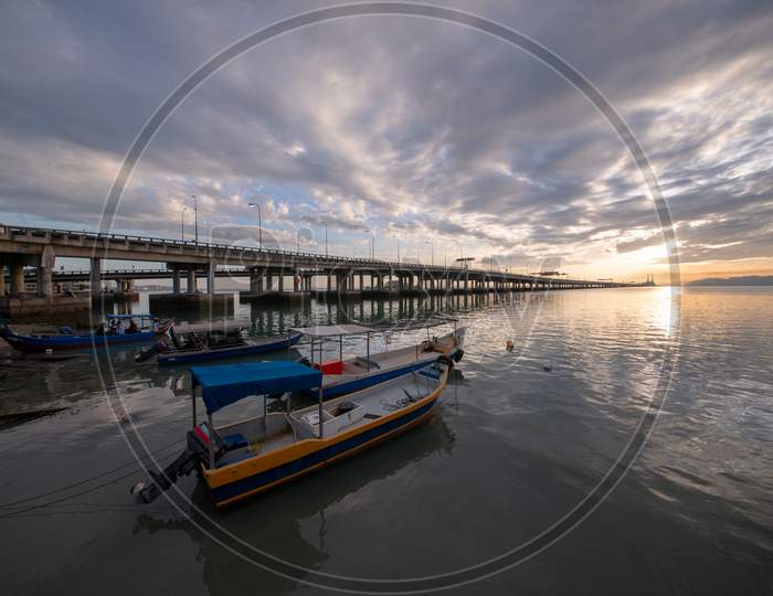 Fishing Boat Park Beside Penang Bridge In Morning Sun Rise