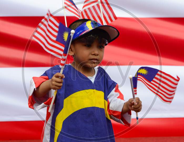 A Kids Wear Malaysia Flag And Hold Malaysia Flag