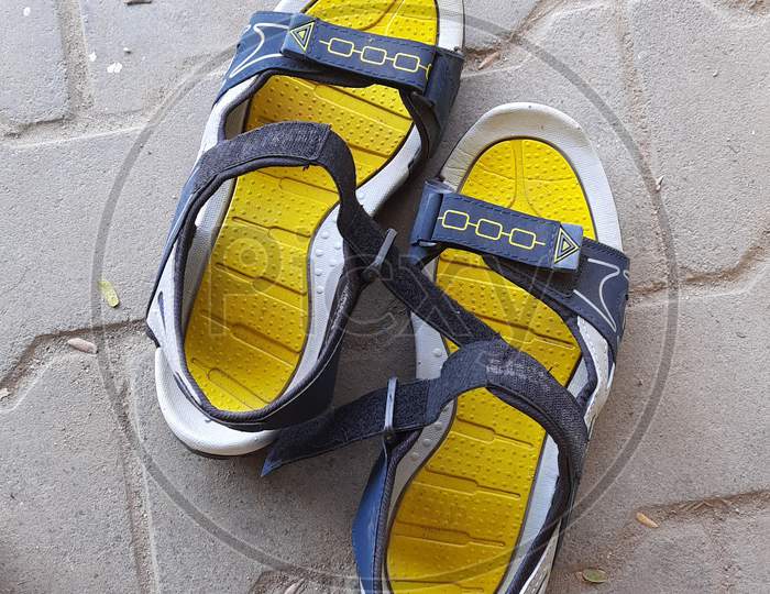 Closeup Of Yellow Color Sandals In A Empty Road