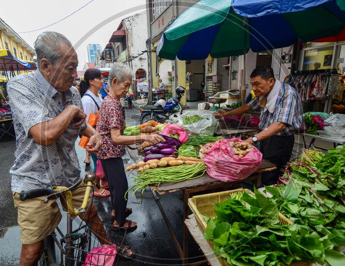 People Buy Vegetables At Wet Market In The Street