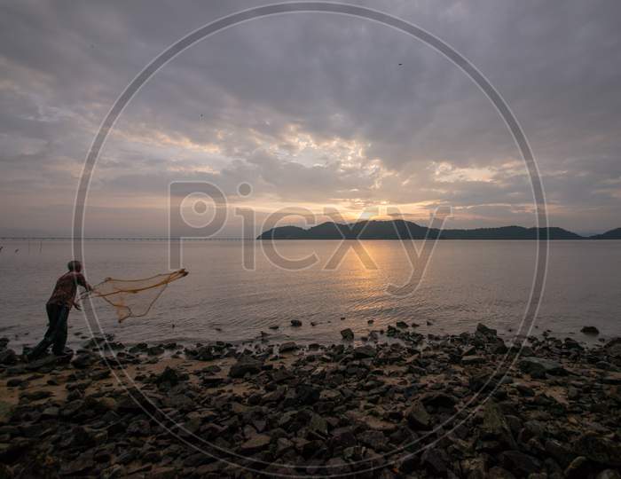 Fisherman Catch Fish With Net