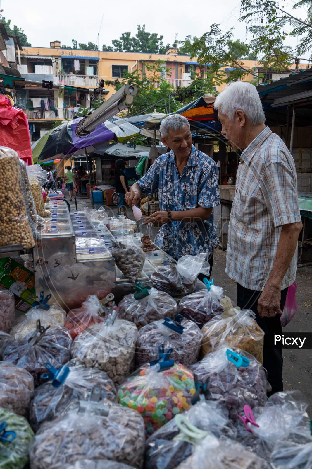 An Elder Buy Candy From Morning Market At Jelutong