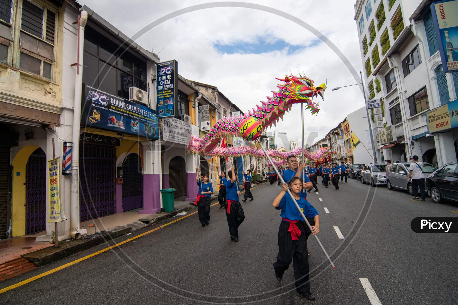 Group Of Man Perform Dragon Dance At Street