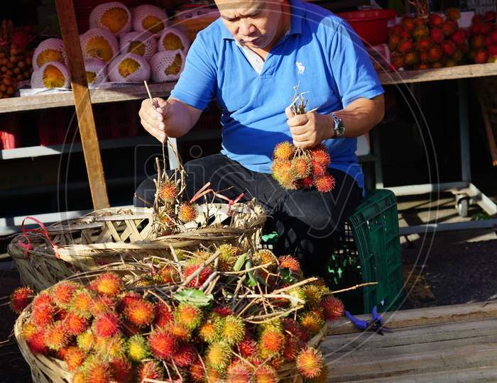 Seller Sell The Rambutan In Basket