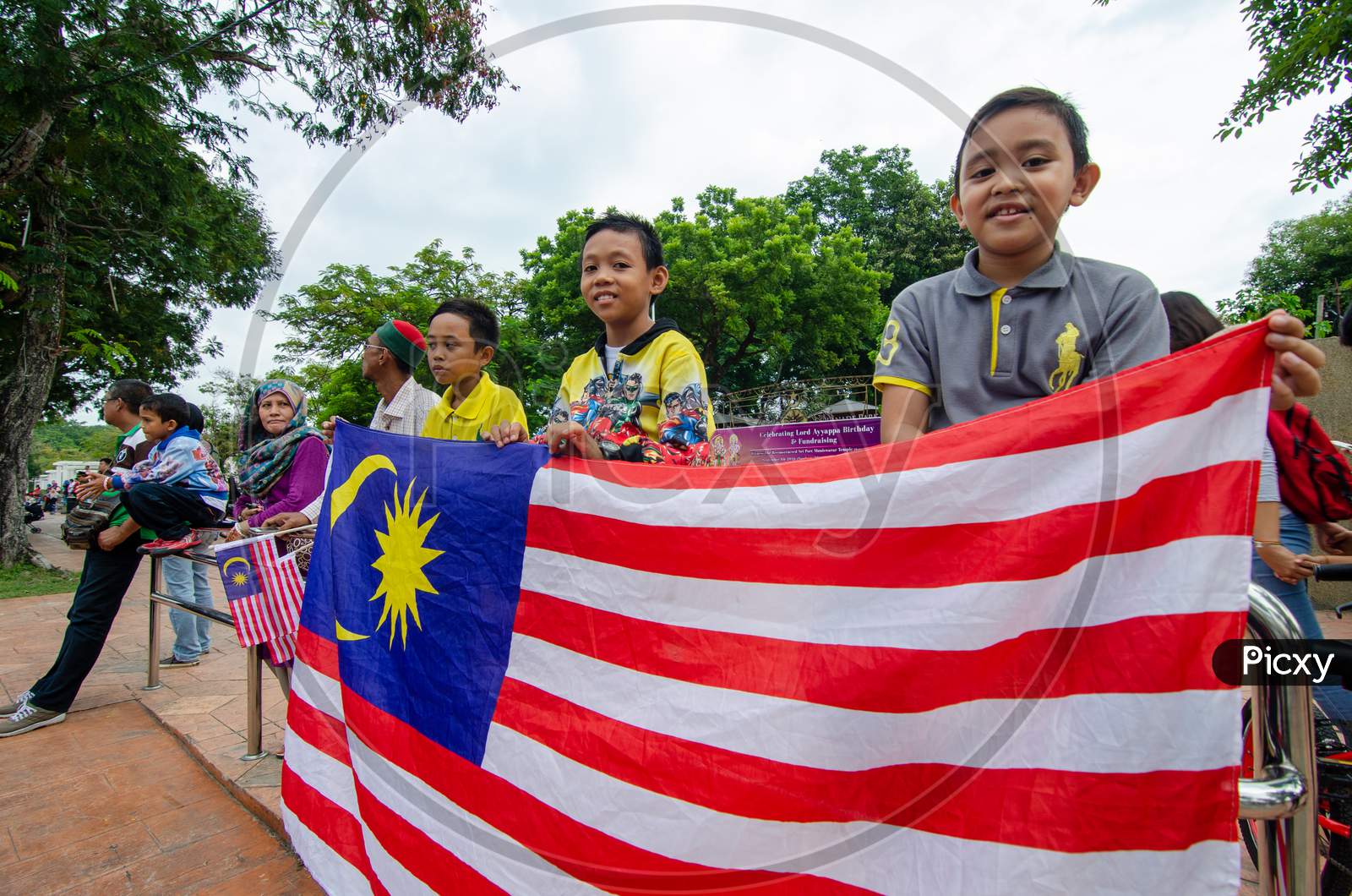 Kids Hold The Malaysia Flag During Independence Procession