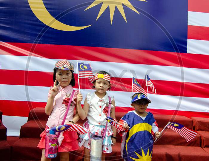 Different Ethnic Hold Malaysia Flag In Front Of Malaysia Flag