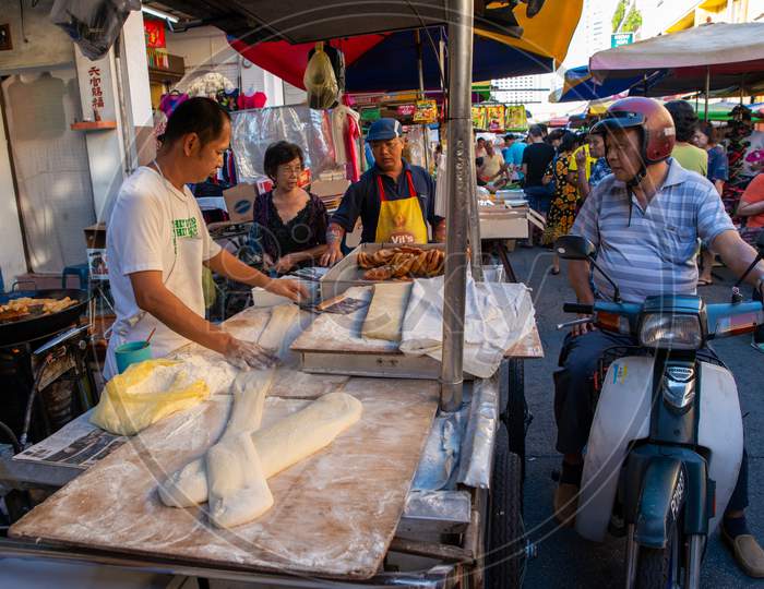 A Man Ride Motor To Buy Deep Fried Dough Stall In Morning Market