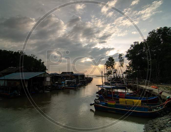 Traditional Malays Fishing Village During Sunset Hour With Dramatic Colorful Cloud