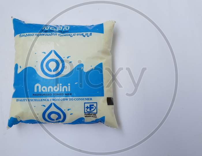 Closeup of Blue Color Nandini Pasteurised Toned Milk 500ml Pouch isolated on white background