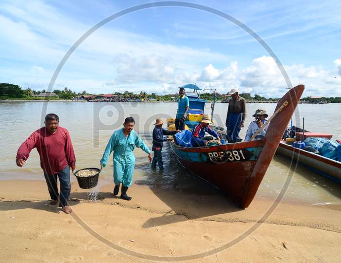 Fishermen Carry The Basket Full Of Prawn To Sell At Market