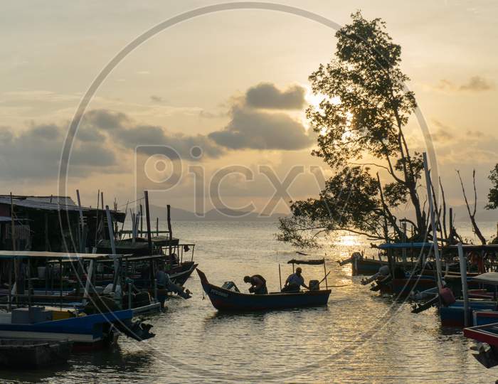 A Boat Come Back From Sea At Malays Fishing Village During Sun Down