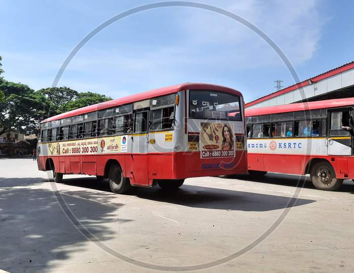 Closeup of KSRTC Bus Stand and Building with Buses pickup and drop of passengers in a station.