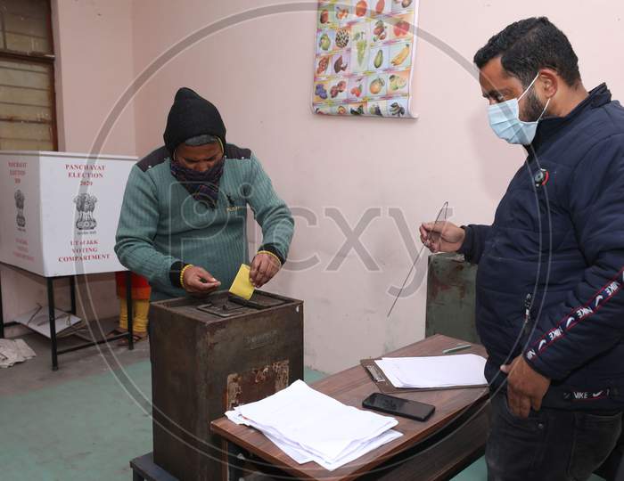 Villager cast their votes during the second phase of the District Development Council (DDC) elections at Meen Sarkar Sambha in Jammu, Tuesday, Dec. 1, 2020.